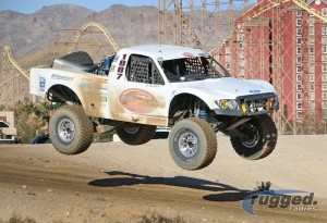 white race truck in airborne during race