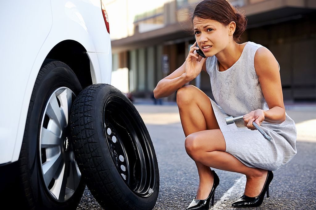 tire being changed by professional woman